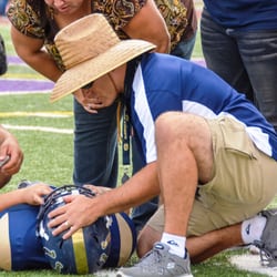 Dr. Clarizio, Team Doctor for the Glendale Bears assessing an injury.