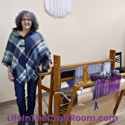 Life in the Craft Room - Weaving instructor Carolyn Sklarchyk next to a floor loom