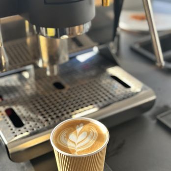 Ignition Coffee - a cup of cappuccino in front of a coffee machine - Coffee & Tea Near Me - Honolulu, Hawaii Ignition Coffee - a cup of cappuccino in front of a coffee machine - Coffee & Tea Near Me - Honolulu, Hawaii