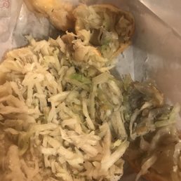 a hot dog with coleslaw on a bun