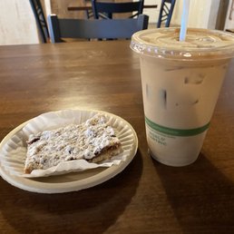 Iced latte and a shortbread square with fruit filling Iced latte and a shortbread square with fruit filling