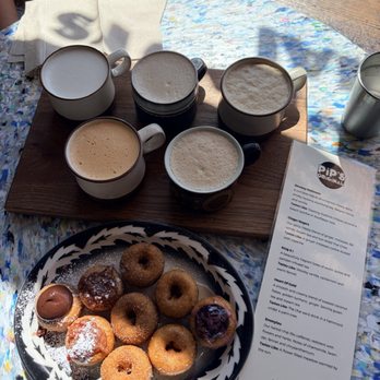 Pip's Original Doughnuts & Chai - Flight of Chai (6 oz.) Hot Doughnuts (8): Cinnamon sugar, raw honey, brownie batter, blueberry wild rose, and Bacon maple jam - Coffee & Tea Near Me - Portland, Oregon Pip's Original Doughnuts & Chai - Flight of Chai (6 oz.) Hot Doughnuts (8): Cinnamon sugar, raw honey, brownie batter, blueberry wild rose, and Bacon maple jam - Coffee & Tea Near Me - Portland, Oregon