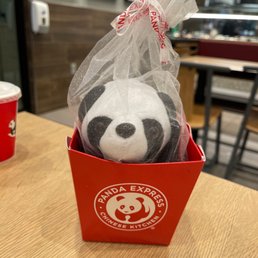 a stuffed panda in a red box