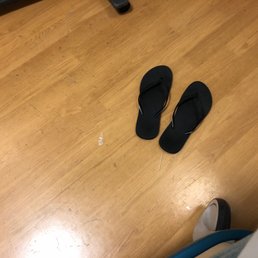 Sutters dirty floors with used toothpicks and trash pieces next to my flip flops