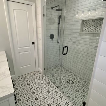 Procida Tile - a walk in shower with a glass door - Flooring Near Me - Deer Park, New York