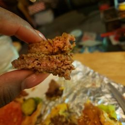 a hand holding a piece of food