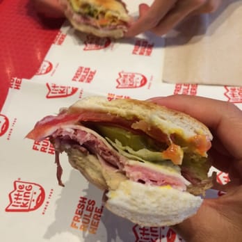 Little King - a person holding a sandwich in their hand - Delis Near Me - Omaha, Nebraska