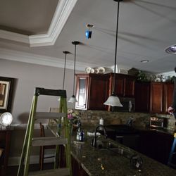 Stoneridge Homes - Two pendant lights are not secured.  A contractor is installing a 2x4 to attach the electrical box to because it just was shoved up within c