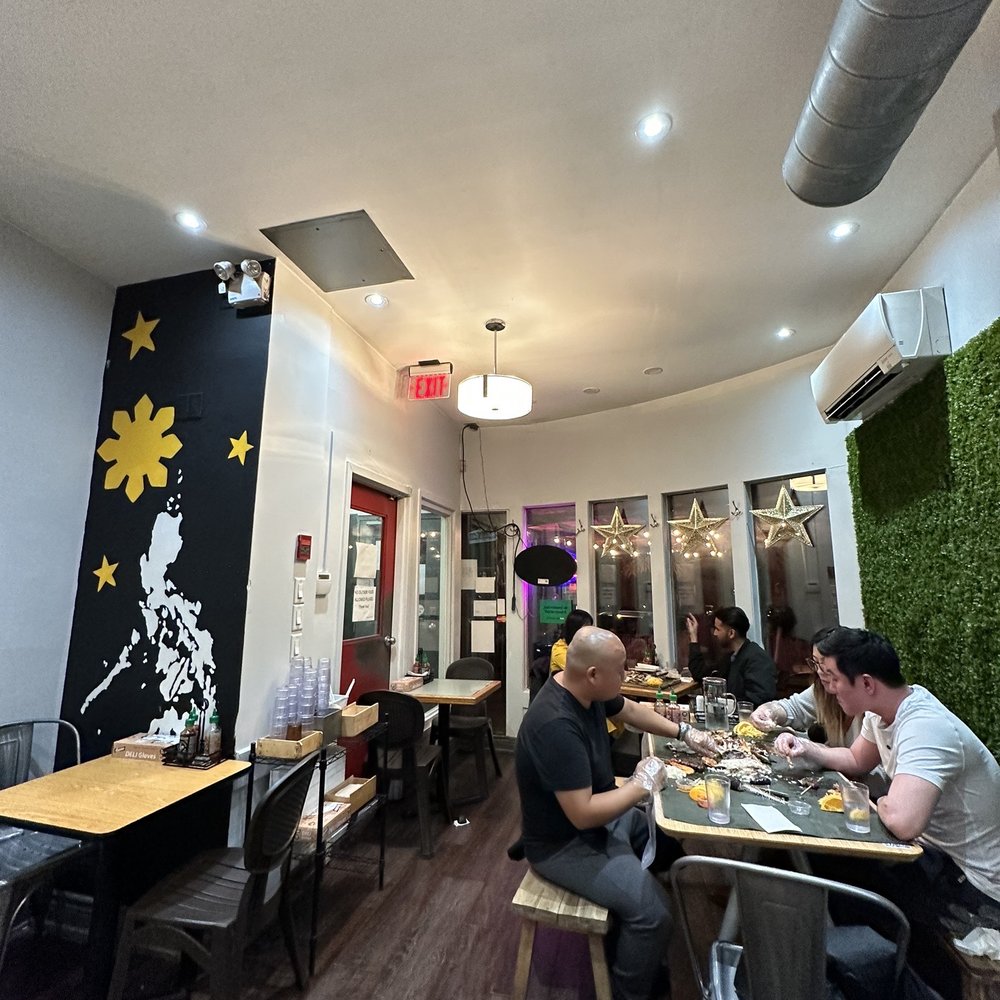 Tinuno - a group of people sitting at tables in a restaurant - Filipino Near Me - Toronto, Ontario Tinuno - a group of people sitting at tables in a restaurant - Filipino Near Me - Toronto, Ontario