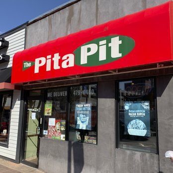 Pita Pit - a woman walking past a pita pit restaurant - Mediterranean Near Me - Syracuse, New York