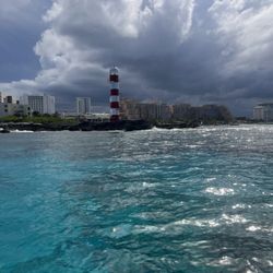 Playa Caracol - Parasailing  and beautiful views and lighthouse. Beautiful skies and great clouds and beautiful beaches and beautiful sunny  skies