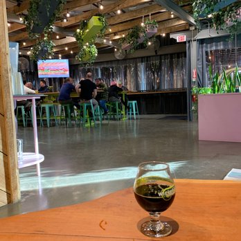 Wicked Weed West - a glass of beer on a table - Brewpubs Near Me - Candler, North Carolina Wicked Weed West - a glass of beer on a table - Brewpubs Near Me - Candler, North Carolina
