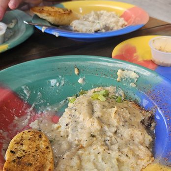 The Oar House - Fish and Grits (grouper and grits I think) -one serving split between 2 bowls. - American Near Me - Pensacola, Florida