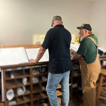 Mike Seeders Plumbing - Two team members review construction blueprints at a drafting station, discussing project details and planning residential pl... - Plumbing Near Me - Tallahassee, Florida Mike Seeders Plumbing - Two team members review construction blueprints at a drafting station, discussing project details and planning residential pl... - Plumbing Near Me - Tallahassee, Florida