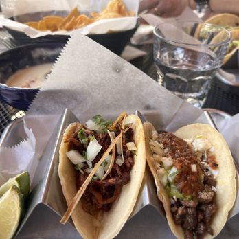 COMO - Queso and chip dip, salsa negra taco, and carnitas taco. - Mexican Near Me - Truckee, California