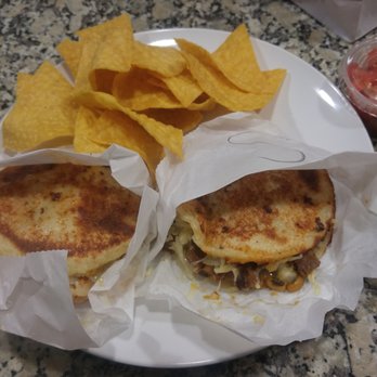 Guasaca - Signature tilapia arepa on the left. Signature steak arepa on the right. Chips in the back. - Venezuelan Near Me - Cary, North Carolina