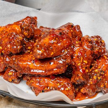 Wing Squad - a plate of chicken wings and a cup of beer - Food Delivery Services Near Me Wing Squad - a plate of chicken wings and a cup of beer - Food Delivery Services Near Me