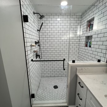 FSA Construction & Electrical - a bathroom with a black and white tiled floor - General Contractors Near Me - Clinton, Massachusetts