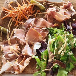 Savory crepe filled with cheese and topped with ham and salad. Savory crepe filled with cheese and topped with ham and salad.