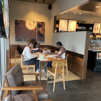Starbucks - two people sitting at a table in a coffee shop - Coffee & Tea Near Me - Royal Palm Beach, Florida Starbucks - two people sitting at a table in a coffee shop - Coffee & Tea Near Me - Royal Palm Beach, Florida