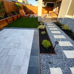 Long view of tile patio #1, walkways with planter beds and turf installed.