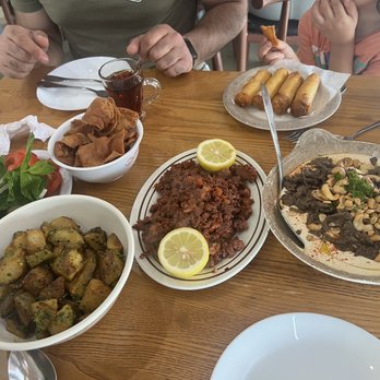 AlTayeb Of Dearborn - Yea pot, fetta tahini with meat, hummus, spicy potatoes, cheese rolls, beef and tomatoes plate! - Breakfast & Brunch Near Me - Dearborn, Michigan