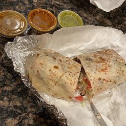 a burrito and condiments a burrito and condiments