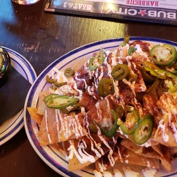 Bub City - Pulled pork nachos ($16) are AWESOME. Homemade chips with queso, sour cream, jalapenos, and a dusting of cayenne - Bars Near Me - Rosemont, Illinois Bub City - Pulled pork nachos ($16) are AWESOME. Homemade chips with queso, sour cream, jalapenos, and a dusting of cayenne - Bars Near Me - Rosemont, Illinois