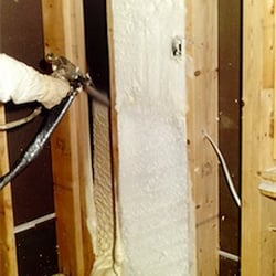 Keeney Home Services - Spray foam insulation being applied to an attic