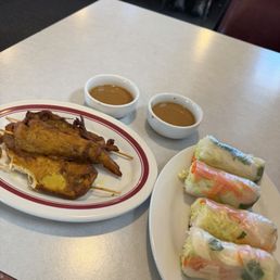 Spring rolls and chicken satay Spring rolls and chicken satay