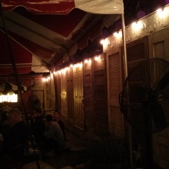 Home Slice Pizza - Back patio area with several tables and cool decor. - Pizza Near Me - Austin, Texas Home Slice Pizza - Back patio area with several tables and cool decor. - Pizza Near Me - Austin, Texas