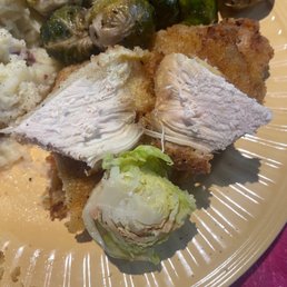Dry Chicken Scollopini and Uncooked/Raw Roasted Brussel Sprouts. Dry Chicken Scollopini and Uncooked/Raw Roasted Brussel Sprouts.