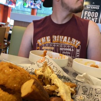 Wings and Rings - Appetizer sampler (again) with pretzel bites, parmesan garlic aioli fries, and onion rings. also my boyfriend is deep into watching the game - Chicken Wings Near Me - Port Charlotte, Florida