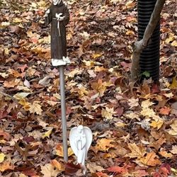 Ambati Flowers - A small white religious figurine next to a Saint Francis statue in a fall garden.