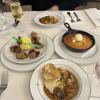 Broussard's Restaurant & Courtyard - Shrimp and grits. Roasted garlic oysters. Cornbread - Seafood Near Me - New Orleans, Louisiana Broussard's Restaurant & Courtyard - Shrimp and grits. Roasted garlic oysters. Cornbread - Seafood Near Me - New Orleans, Louisiana