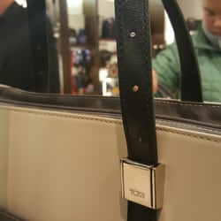 Tumi Store - (",)