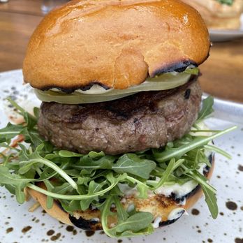 Manuela - Venison Burger, Pickled Green Tomato, Arugula, Crisp Leeks, Garlic Aioli, Brioche Bun - New American Near Me - Los Angeles, California Manuela - Venison Burger, Pickled Green Tomato, Arugula, Crisp Leeks, Garlic Aioli, Brioche Bun - New American Near Me - Los Angeles, California