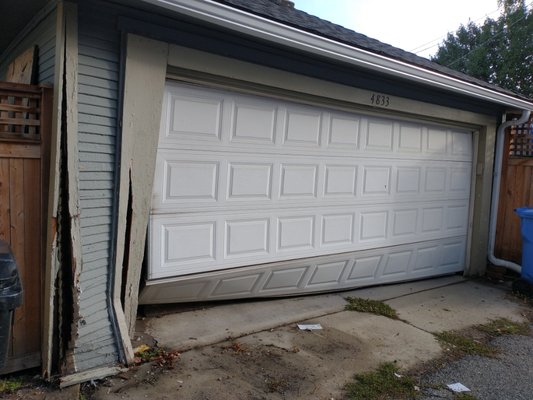 Damage corner - This garage was hit by a car damaging the garage door and corner. Damage corner - This garage was hit by a car damaging the garage door and corner.