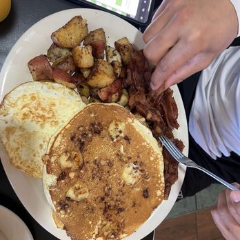 Goldman's Bagel Deli - pancakes with over medium eggs a stack of bacon and potatoes - Delis Near Me - Key West, Florida Goldman's Bagel Deli - pancakes with over medium eggs a stack of bacon and potatoes - Delis Near Me - Key West, Florida