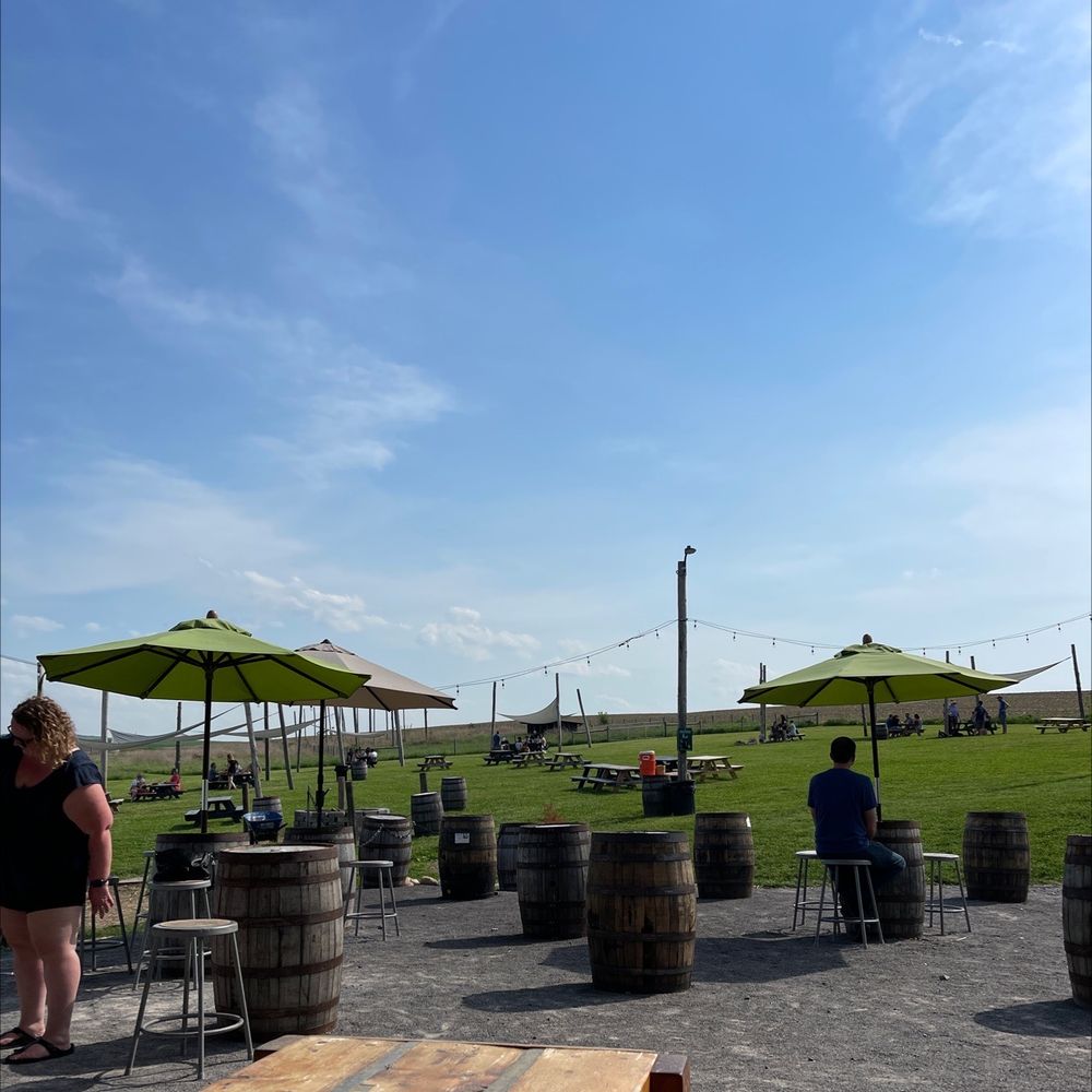 Other Half Brewing Company - a group of people sitting under umbrellas - Breweries Near Me - Bloomfield, New York