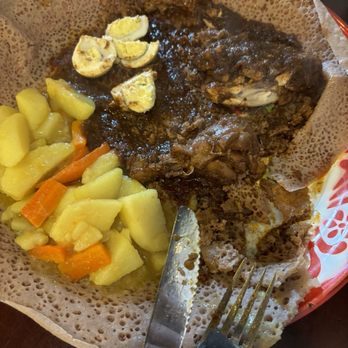 Ambo Ethiopian Cuisine - The chicken stew dish with a side of carrots and potato stew. - Ethiopian Near Me - Bellingham, Washington
