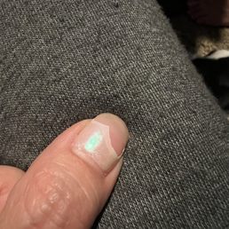 Fingernail polish comes off in a sheet.