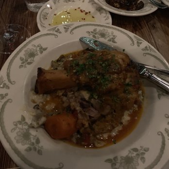 Osteria Tulia - Braised Heritage Pork Osso Buco with Parmesan/Mushroom Risotto - Italian Near Me - Naples, Florida Osteria Tulia - Braised Heritage Pork Osso Buco with Parmesan/Mushroom Risotto - Italian Near Me - Naples, Florida