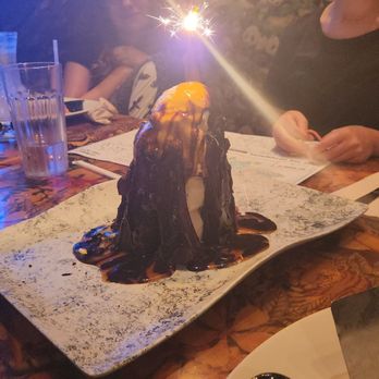 Rainforest Cafe - The volcano dessert - brownie, ice cream and whipped cream - American Near Me - Gurnee, Illinois Rainforest Cafe - The volcano dessert - brownie, ice cream and whipped cream - American Near Me - Gurnee, Illinois