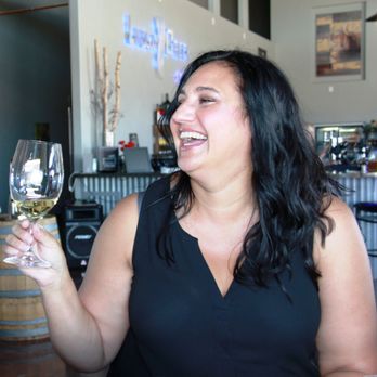 Twisted Vine Wine Tours - A tour guest enjoying a glass of wine at Lindsey Creek Vineyards. - Wine Tours Near Me Twisted Vine Wine Tours - A tour guest enjoying a glass of wine at Lindsey Creek Vineyards. - Wine Tours Near Me