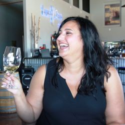 Twisted Vine Wine Tours - A tour guest enjoying a glass of wine at Lindsey Creek Vineyards.