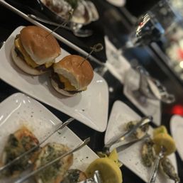 Oyster rockafella. Waygu sliders. Waygu meatballs with melted Barrada cheese Oyster rockafella. Waygu sliders. Waygu meatballs with melted Barrada cheese