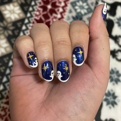 AYS Nail Spa - Ghost and Star nails on a dark blue background. Stars are metallic gold and the ghosts extend from the French tip.