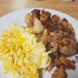 Scrambled eggs with cheese and home fries.