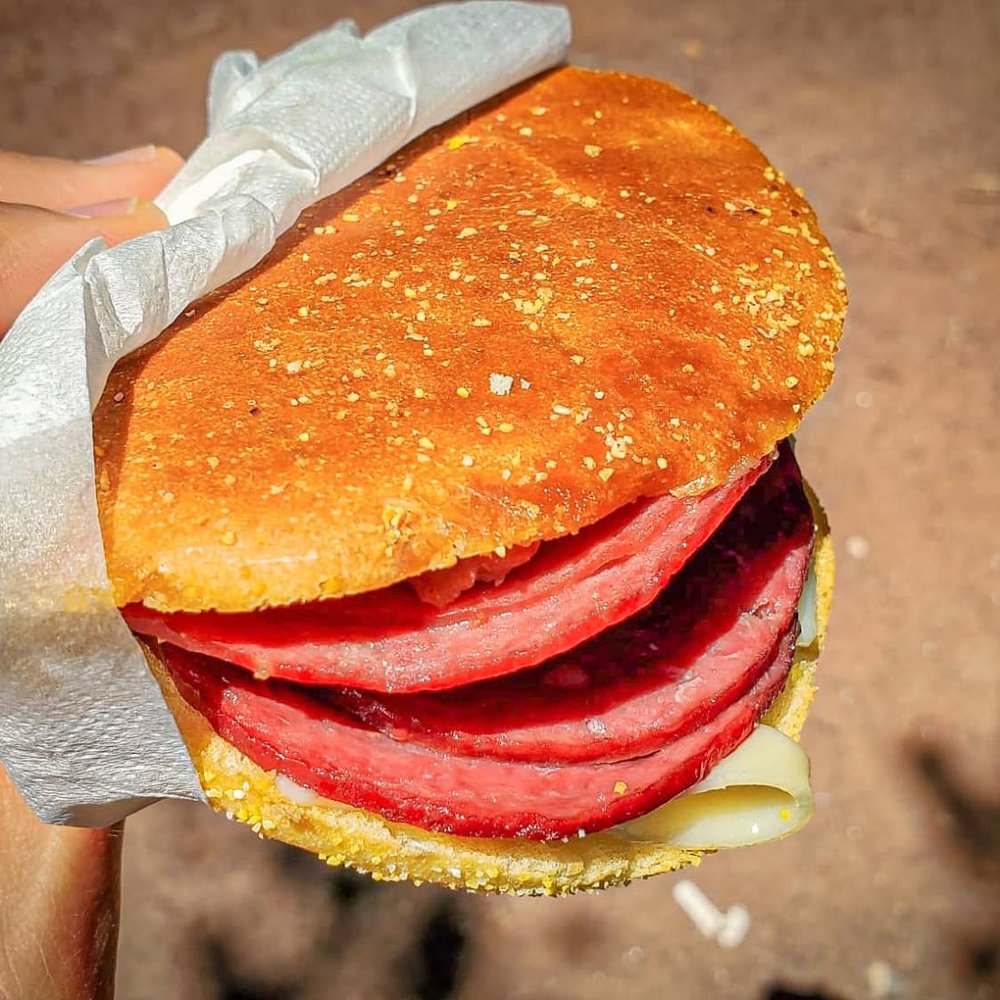 Wilensky - a hand holding a sandwich with meat and cheese - Delis Near Me - Montreal, Quebec Wilensky - a hand holding a sandwich with meat and cheese - Delis Near Me - Montreal, Quebec